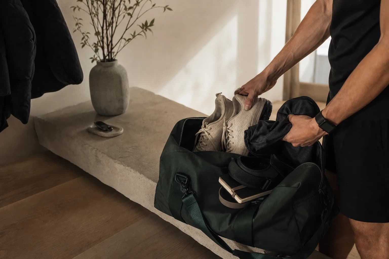 An athlete packing shoes and training gear for the week ahead